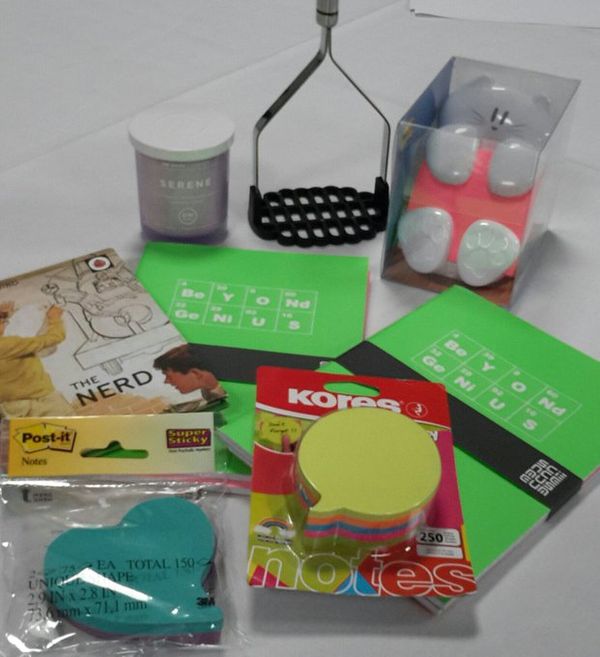 Photo of prizes inc cat shaped post-it holder, candle, ladybird book The Nerd & potato masher